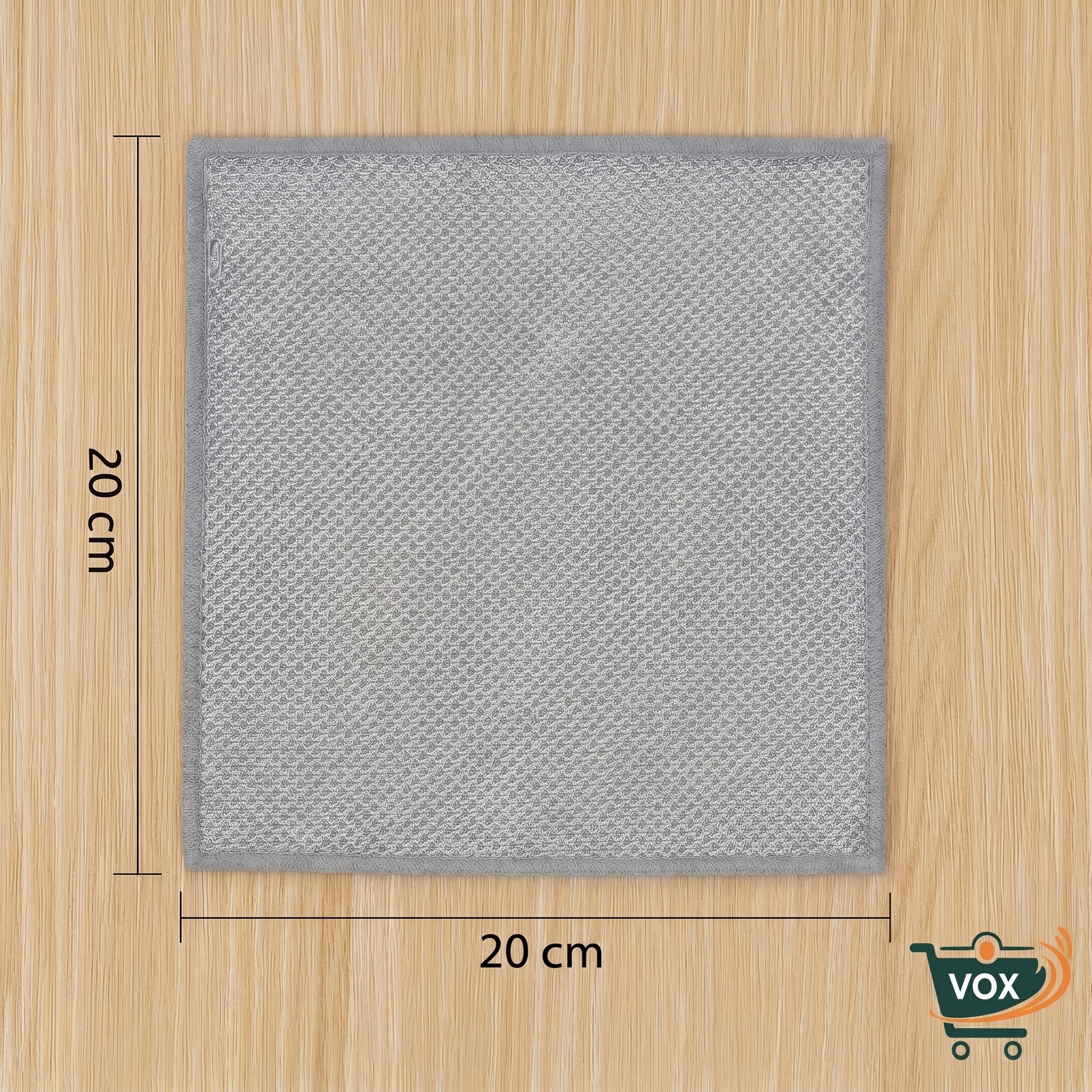 Gray square mat with dimensions on a wooden surface, featuring the VOX brand.